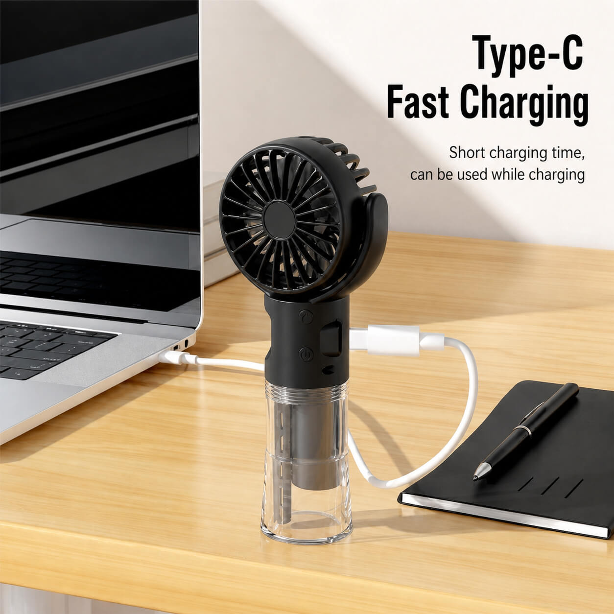 Black handheld fan on a desk with a laptop and notebook, featuring Type-C fast charging text.